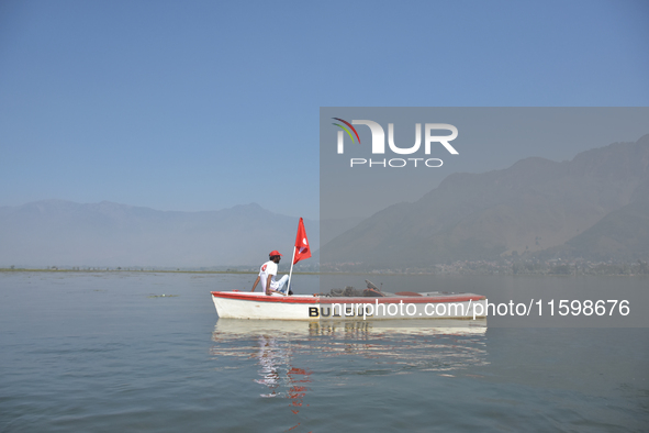 Supporters of the National Conference, a regional political party, hold a boat rally ahead of the second phase of assembly elections in Dal...