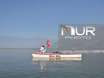 Supporters of the National Conference, a regional political party, hold a boat rally ahead of the second phase of assembly elections in Dal...