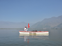 Supporters of the National Conference, a regional political party, hold a boat rally ahead of the second phase of assembly elections in Dal...