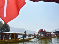 Supporters of the National Conference, a regional political party, hold a boat rally ahead of the second phase of assembly elections in Dal...