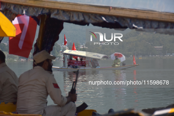 Supporters of the National Conference, a regional political party, hold a boat rally ahead of the second phase of assembly elections in Dal...