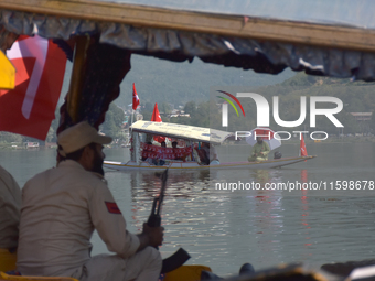 Supporters of the National Conference, a regional political party, hold a boat rally ahead of the second phase of assembly elections in Dal...