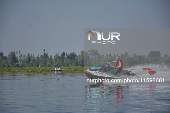 Omar Abdullah, leader of the National Conference, a regional political party, rides a jet ski during a boat rally ahead of the second phase...