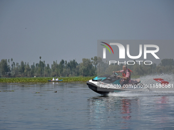 Omar Abdullah, leader of the National Conference, a regional political party, rides a jet ski during a boat rally ahead of the second phase...