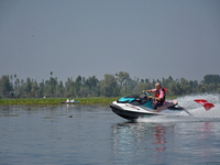 Omar Abdullah, leader of the National Conference, a regional political party, rides a jet ski during a boat rally ahead of the second phase...