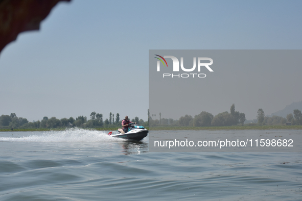 Omar Abdullah, leader of the National Conference, a regional political party, rides a jet ski during a boat rally ahead of the second phase...