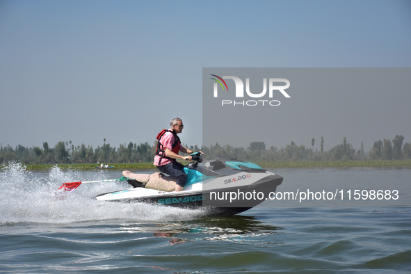 Omar Abdullah, leader of the National Conference, a regional political party, rides a jet ski during a boat rally ahead of the second phase...