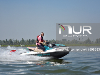 Omar Abdullah, leader of the National Conference, a regional political party, rides a jet ski during a boat rally ahead of the second phase...