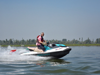 Omar Abdullah, leader of the National Conference, a regional political party, rides a jet ski during a boat rally ahead of the second phase...