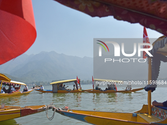 Supporters of the National Conference, a regional political party, hold a boat rally ahead of the second phase of assembly elections in Dal...