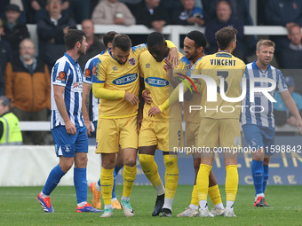 Josh Umerah of Dagenham & Redbridge celebrates with his teammates after scoring their first goal during the Vanarama National League match b...