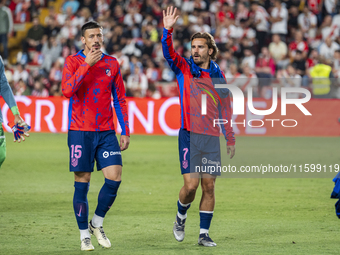 Clement Lenglet of Atletico de Madrid (L) and Antoine Griezmann of Atletico de Madrid (R) enter the field during the La Liga EA Sports 2024/...