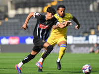 George Abbott of Notts County battles with Jayden Clarke of Gillingham during the Sky Bet League 2 match between Notts County and Gillingham...