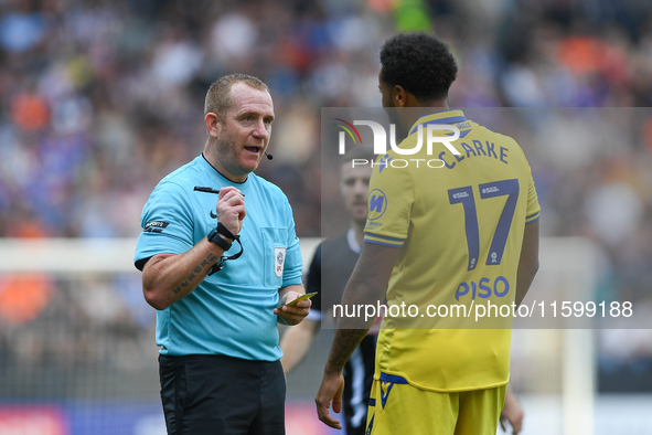 Referee Lee Swabey books Jayden Clarke of Gillingham during the Sky Bet League 2 match between Notts County and Gillingham at Meadow Lane in...