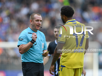 Referee Lee Swabey books Jayden Clarke of Gillingham during the Sky Bet League 2 match between Notts County and Gillingham at Meadow Lane in...