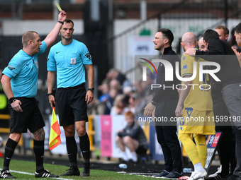 Referee Lee Swabey shows a yellow card to Stuart Maynard, manager of Notts County, during the Sky Bet League 2 match between Notts County an...