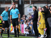 Referee Lee Swabey shows a yellow card to Stuart Maynard, manager of Notts County, during the Sky Bet League 2 match between Notts County an...