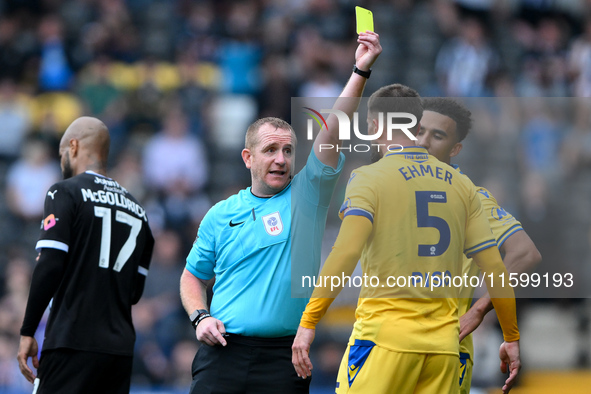 Referee Lee Swabey shows a yellow card to Max Ehmer of Gillingham during the Sky Bet League 2 match between Notts County and Gillingham at M...