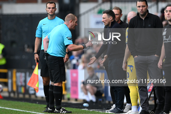 Referee Lee Swabey speaks with Stuart Maynard, manager of Notts County, during the Sky Bet League 2 match between Notts County and Gillingha...