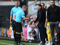 Referee Lee Swabey speaks with Stuart Maynard, manager of Notts County, during the Sky Bet League 2 match between Notts County and Gillingha...