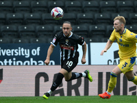 Jodi Jones of Notts County is under pressure from Max Clark of Gillingham during the Sky Bet League 2 match between Notts County and Gilling...