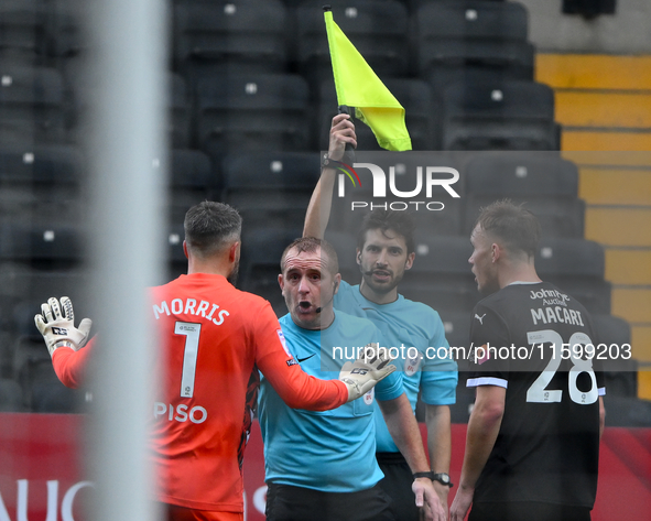 Glenn Morris, Gillingham goalkeeper, and Lewis Macari of Notts County approach referee Lee Swabey after the assistant referee rules County's...