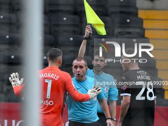 Glenn Morris, Gillingham goalkeeper, and Lewis Macari of Notts County approach referee Lee Swabey after the assistant referee rules County's...