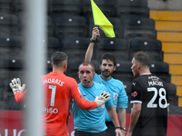 Glenn Morris, Gillingham goalkeeper, and Lewis Macari of Notts County approach referee Lee Swabey after the assistant referee rules County's...