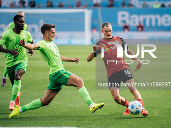 Florian Wirtz of Bayer 04 Leverkusen is in action during the Bundesliga match between Bayer 04 Leverkusen and VfL Wolfsburg at Bay Arena in...