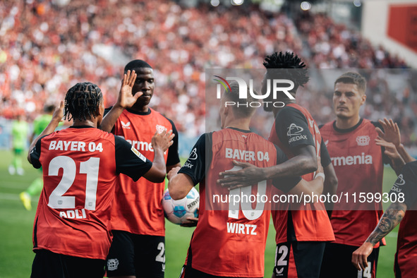 Florian Wirtz of Bayer 04 Leverkusen celebrates his goal with teammates during the Bundesliga match between Bayer 04 Leverkusen and VfL Wolf...