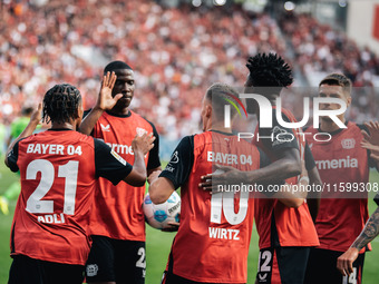 Florian Wirtz of Bayer 04 Leverkusen celebrates his goal with teammates during the Bundesliga match between Bayer 04 Leverkusen and VfL Wolf...