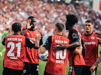 Florian Wirtz of Bayer 04 Leverkusen celebrates his goal with teammates during the Bundesliga match between Bayer 04 Leverkusen and VfL Wolf...