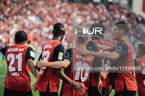 Florian Wirtz of Bayer 04 Leverkusen celebrates his goal with teammates during the Bundesliga match between Bayer 04 Leverkusen and VfL Wolf...