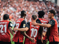 Florian Wirtz of Bayer 04 Leverkusen celebrates his goal with teammates during the Bundesliga match between Bayer 04 Leverkusen and VfL Wolf...