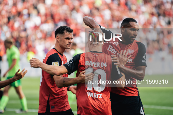 Florian Wirtz of Bayer 04 Leverkusen celebrates his goal with teammates during the Bundesliga match between Bayer 04 Leverkusen and VfL Wolf...