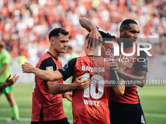 Florian Wirtz of Bayer 04 Leverkusen celebrates his goal with teammates during the Bundesliga match between Bayer 04 Leverkusen and VfL Wolf...