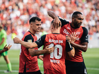 Florian Wirtz of Bayer 04 Leverkusen celebrates his goal with teammates during the Bundesliga match between Bayer 04 Leverkusen and VfL Wolf...