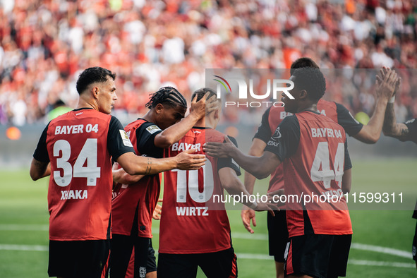 Florian Wirtz of Bayer 04 Leverkusen celebrates his goal with teammates during the Bundesliga match between Bayer 04 Leverkusen and VfL Wolf...