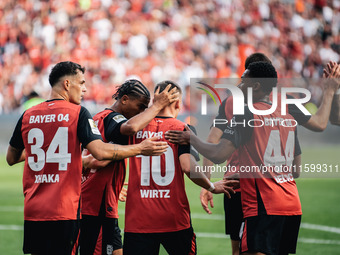 Florian Wirtz of Bayer 04 Leverkusen celebrates his goal with teammates during the Bundesliga match between Bayer 04 Leverkusen and VfL Wolf...