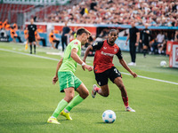 Amine Adli of Bayer 04 Leverkusen is in action during the Bundesliga match between Bayer 04 Leverkusen and VfL Wolfsburg at Bay Arena in Lev...