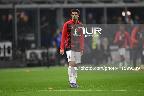 Christian Pulisic of AC Milan warms up prior to the Italian Serie A football match between Inter FC and AC Milan in Milan, Italy, on Septemb...