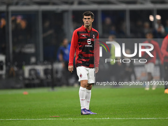 Christian Pulisic of AC Milan warms up prior to the Italian Serie A football match between Inter FC and AC Milan in Milan, Italy, on Septemb...