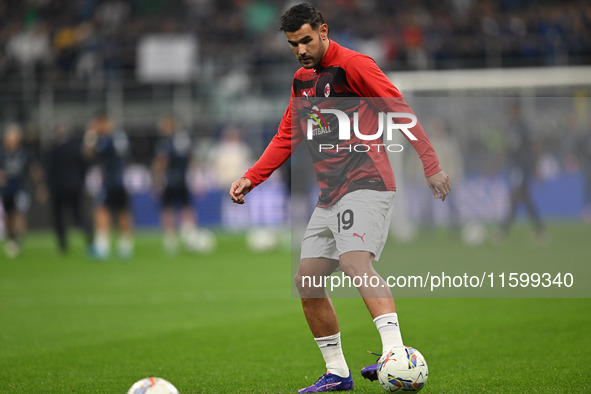 Theo Hernandez of AC Milan warms up prior to the Italian Serie A football match between Inter FC and AC Milan in Milan, Italy, on September...