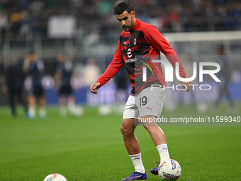 Theo Hernandez of AC Milan warms up prior to the Italian Serie A football match between Inter FC and AC Milan in Milan, Italy, on September...