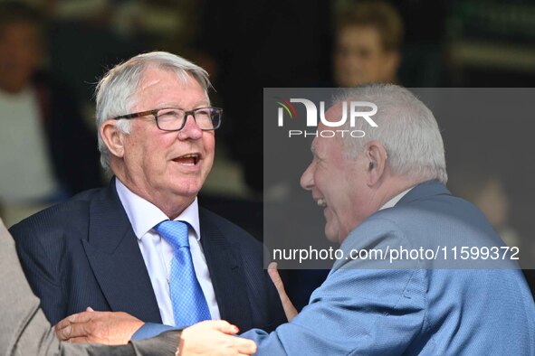 Sir Alex Ferguson converses with Barry Fry during the Sky Bet League 1 match between Peterborough and Bristol Rovers at London Road in Peter...