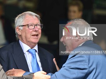 Sir Alex Ferguson converses with Barry Fry during the Sky Bet League 1 match between Peterborough and Bristol Rovers at London Road in Peter...