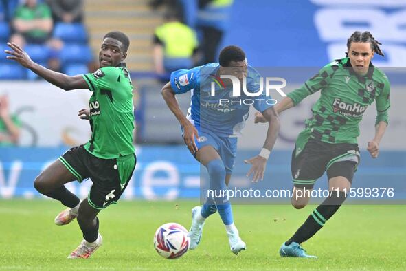 Malik Mothersille (7 Peterborough United) is challenged by Clinton Mola (6 Bristol Rovers) and Kor Shaw (37 Bristol Rovers) during the Sky B...