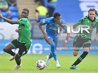 Malik Mothersille (7 Peterborough United) is challenged by Clinton Mola (6 Bristol Rovers) and Kor Shaw (37 Bristol Rovers) during the Sky B...