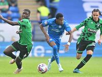 Malik Mothersille (7 Peterborough United) is challenged by Clinton Mola (6 Bristol Rovers) and Kor Shaw (37 Bristol Rovers) during the Sky B...