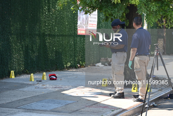 NYPD crime scene investigators search for and collect evidence at the scene outside Wave Juice Bar and Lounge where a 31-year-old man is kil...